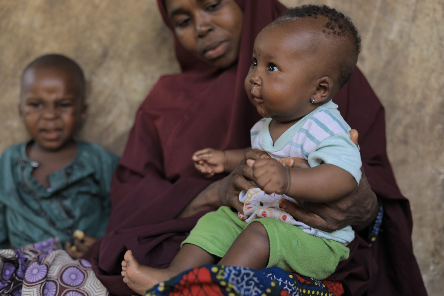 A mother holding her baby in Madobi, Kano State