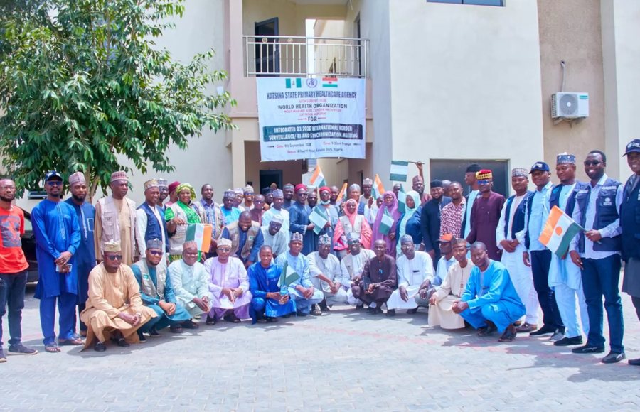 Health officials from Nigeria and Niger pose for a group photograph, holding both national flags